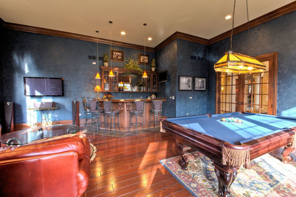 There is a pool table in the middle of the room.