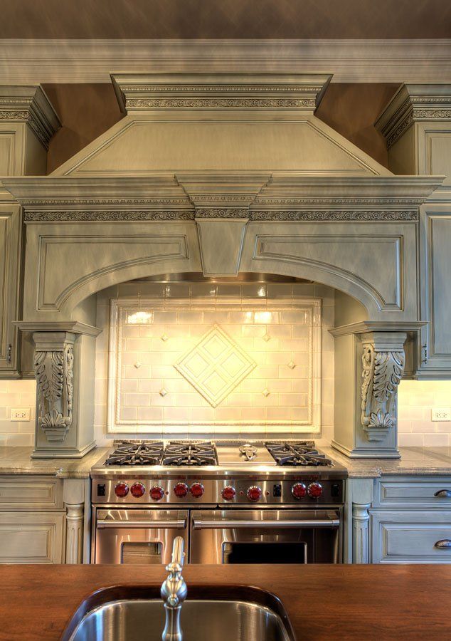 A kitchen with a stove top oven and a sink