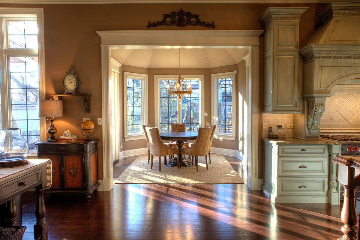 A dining room with a table and chairs in it