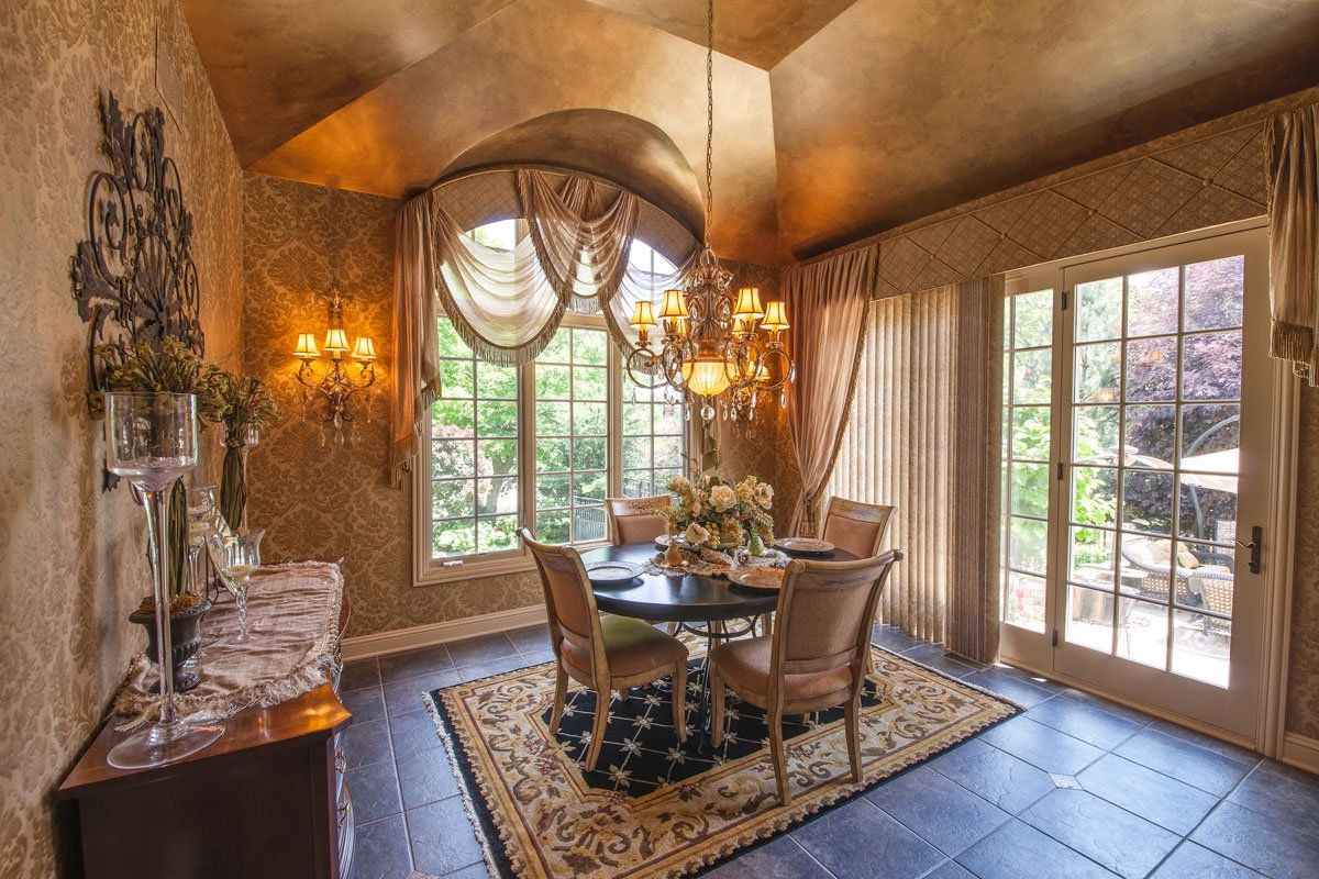 A dining room with a table and chairs and a chandelier.