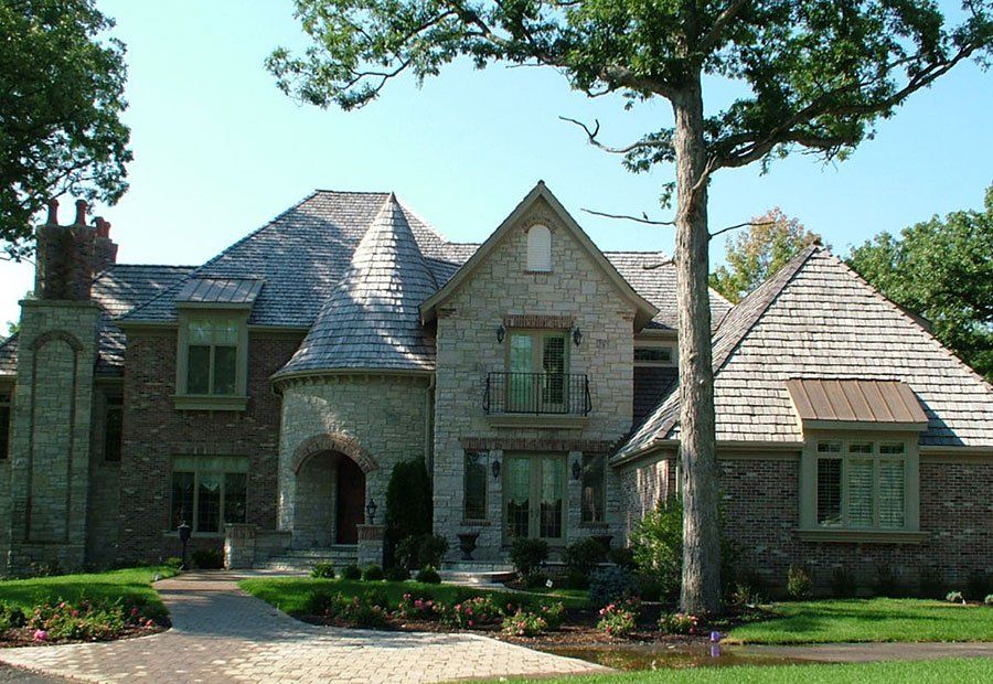 A large house with a tree in front of it