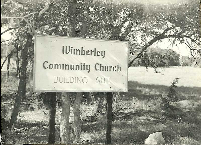 Sign for Wimberley Community Church, building site. Black and white photo.