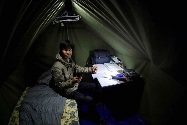 HOPE worker at desk in a tent