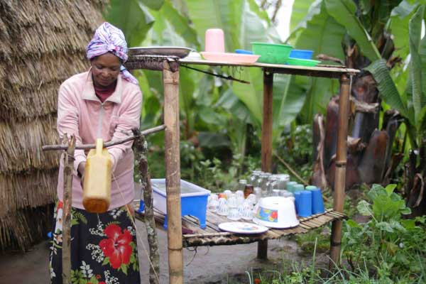 Woman using tippy-tap