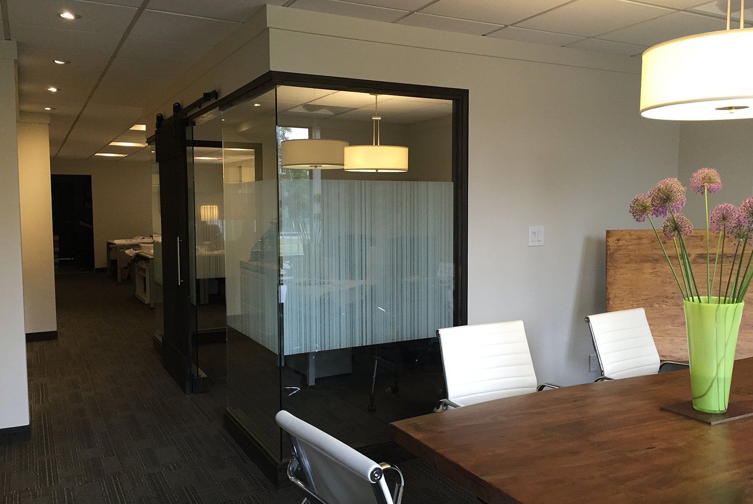 A conference room with a table and chairs in it