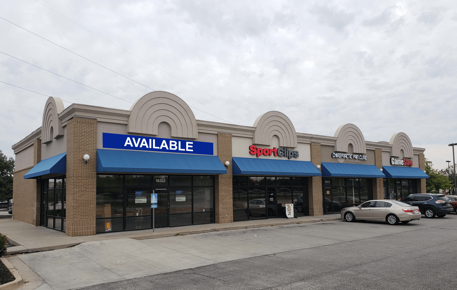 A building with a blue awning that says available on it