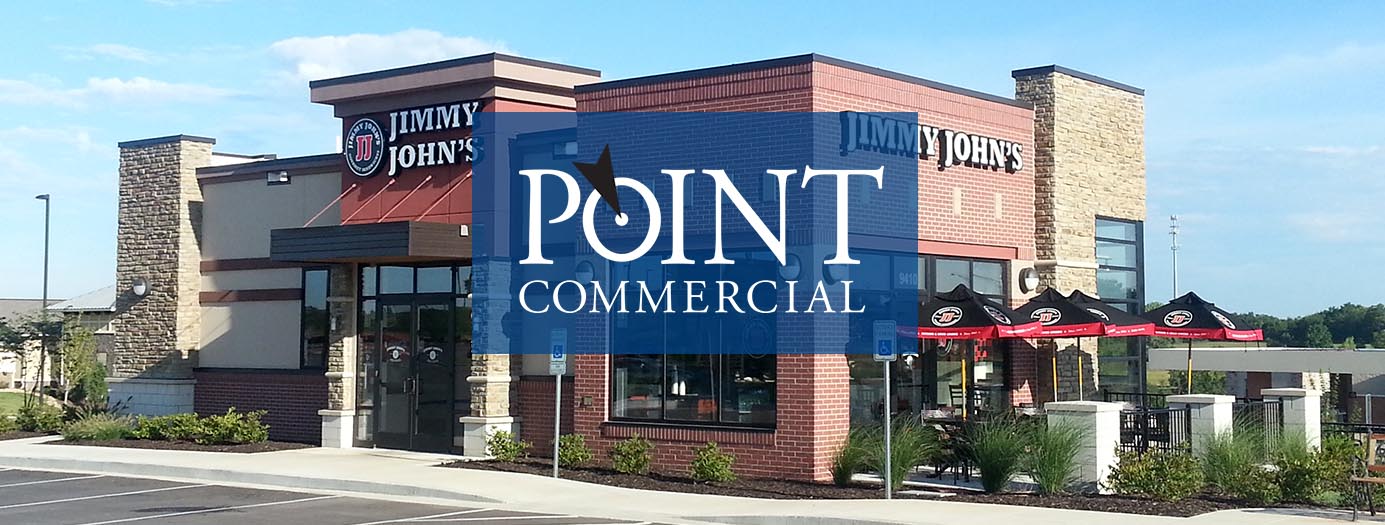 A restaurant with a blue sign that says point commercial