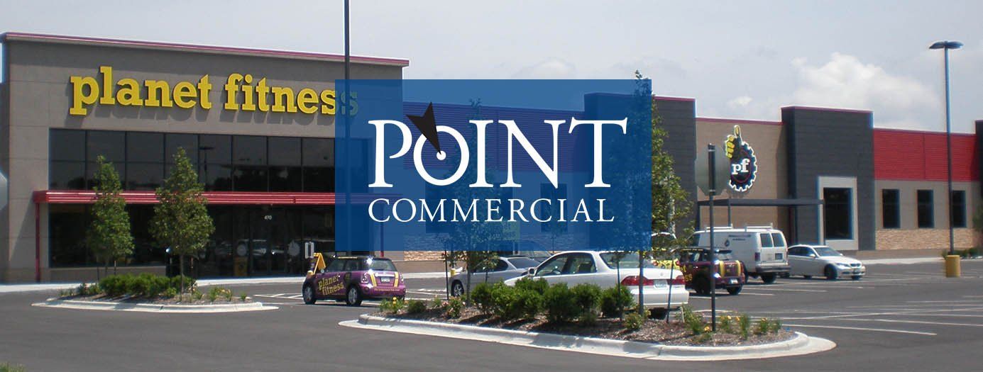 A picture of a planet fitness and point commercial building