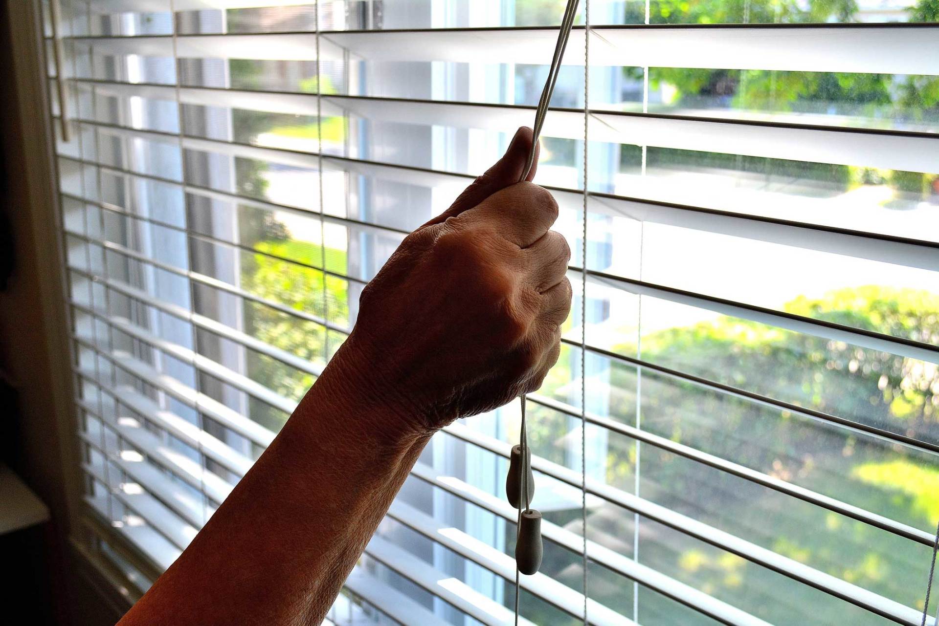 Close Up Of Hand Opening A Window Shade — Belgrade, MT — Blind Guy of Butte Close Up Of Hand Opening A Window Shade — Belgrade, MT — Blind Guy of Butte