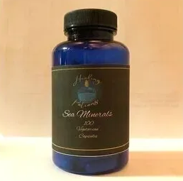 Blue bottle with black cap labeled “Sea Minerals” on a plain background