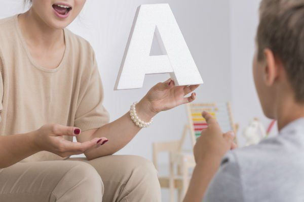 Little boy having a meeting with speech therapist