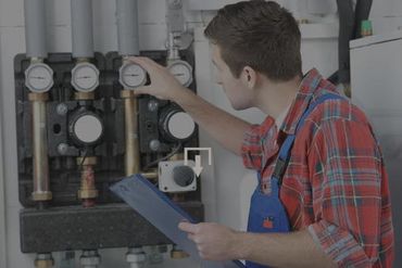 HVAC repair expert checking gauges