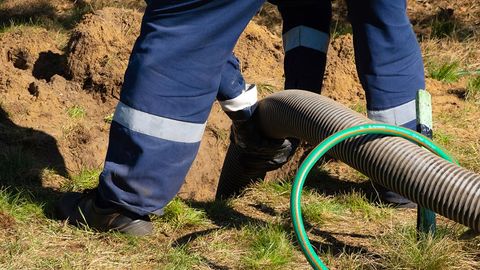 Man Cleaning Sewer — Dubuque, IA — Kluck Construction Man Cleaning Sewer — Dubuque, IA — Kluck Construction
