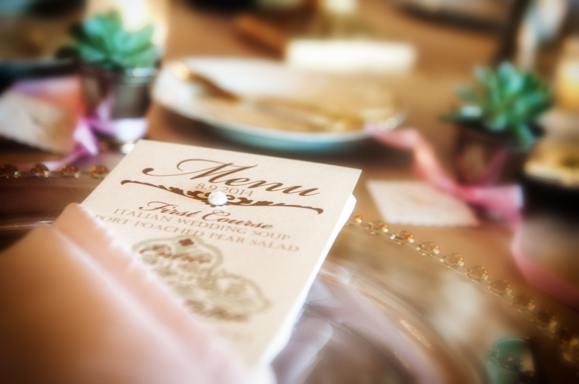 A menu is sitting on a table next to a plate