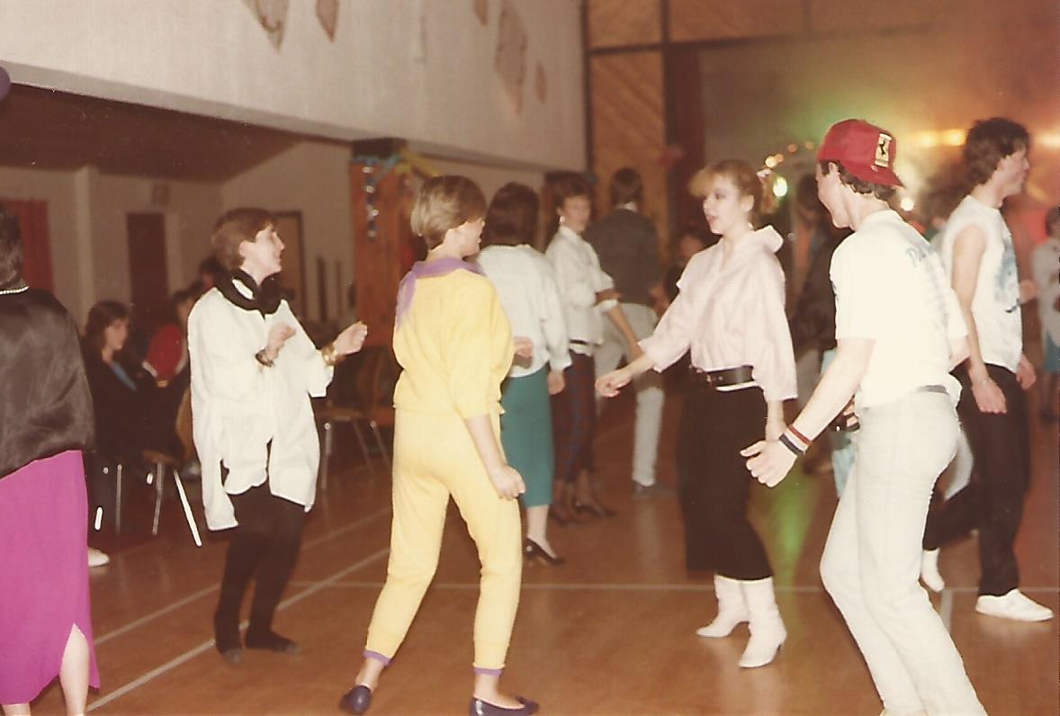 Teenagers dancing in a typical village hall birthday disco.
