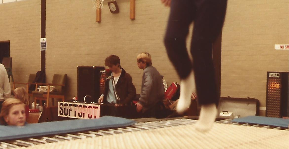 teenager bouncing on trampoline in front of disco.