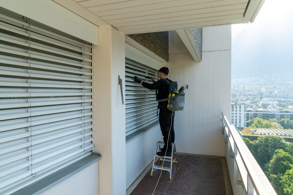 Man Vacuuming Dust in the Window — DS Cleaning Services in Sunshine Coast, QLD