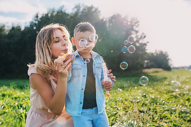 Mother and Son Blowing Bumbles — Belchertown, MA — Law Offices of Richard H Maynard PC Mother and Son Blowing Bumbles — Belchertown, MA — Law Offices of Richard H Maynard PC