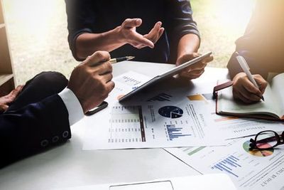 Corporate Tax Preparation — Accountants Doing a Financial Report in Urbandale, IA Corporate Tax Preparation — Accountants Doing a Financial Report in Urbandale, IA