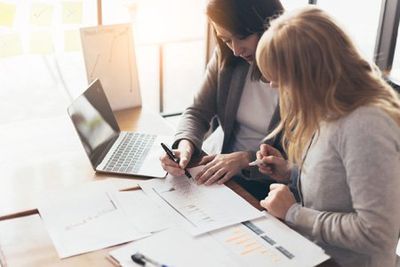 Tax Preparation — Businesswomen Doing an Accounting Report in Urbandale, IA Tax Preparation — Businesswomen Doing an Accounting Report in Urbandale, IA