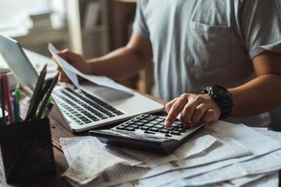 Business Tax Preparation — Man Computing His Tax in Urbandale, IA Business Tax Preparation — Man Computing His Tax in Urbandale, IA