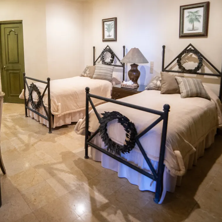 a room with two beds and a lamp