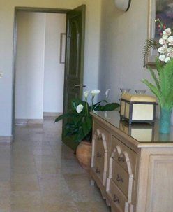 a dresser and a vase of flowers on it .