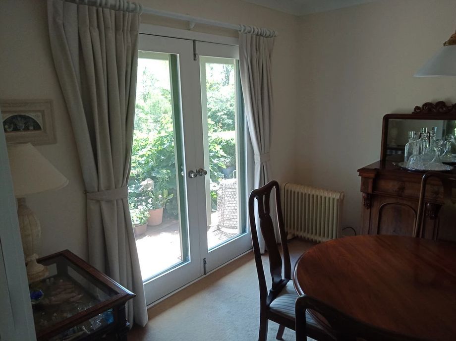 Close door with open curtains, table and chairs - Curtains in Welby, NSW