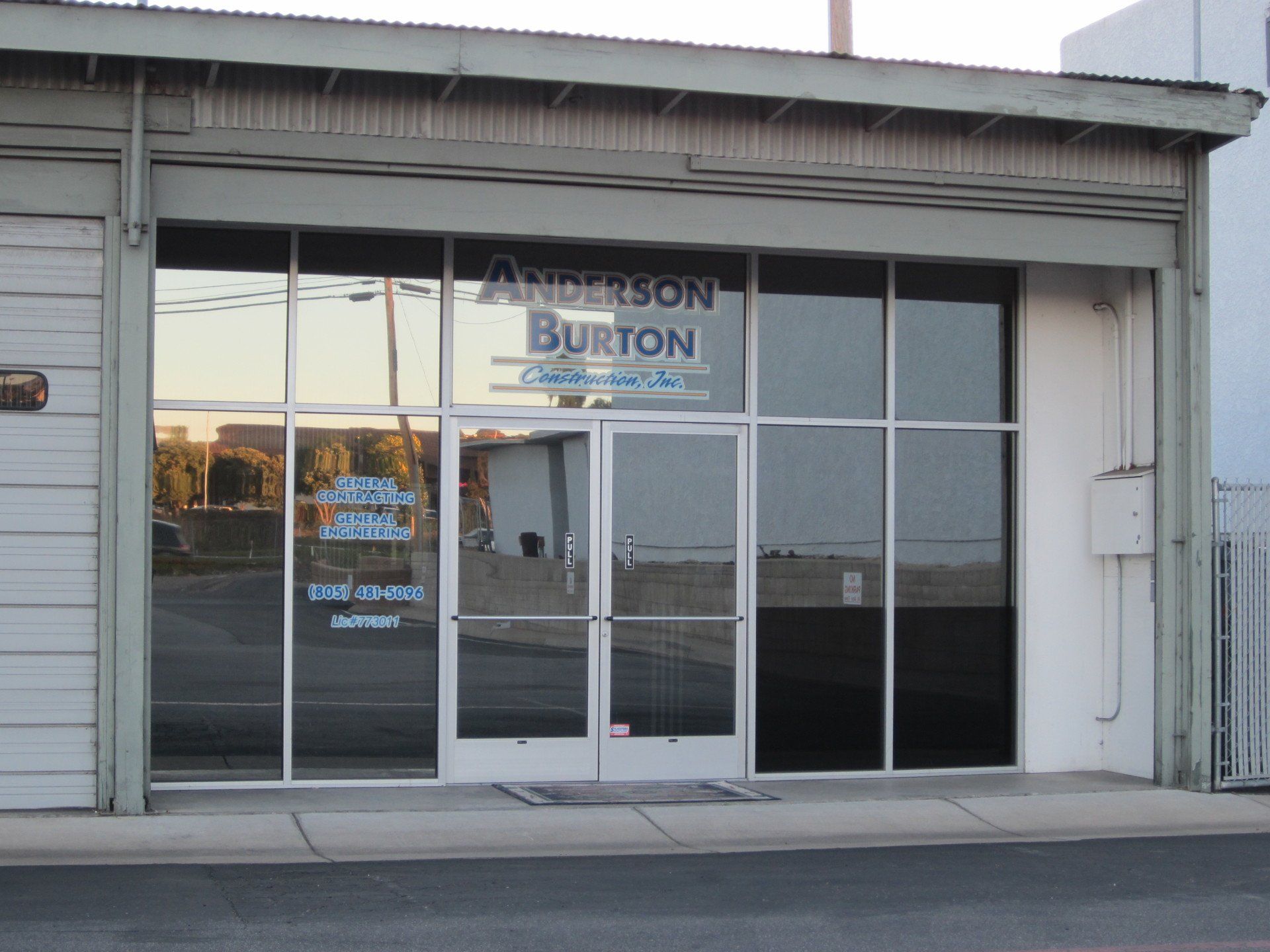 Storefront with glass double doors and windows, displaying the Burton sign above the entrance.