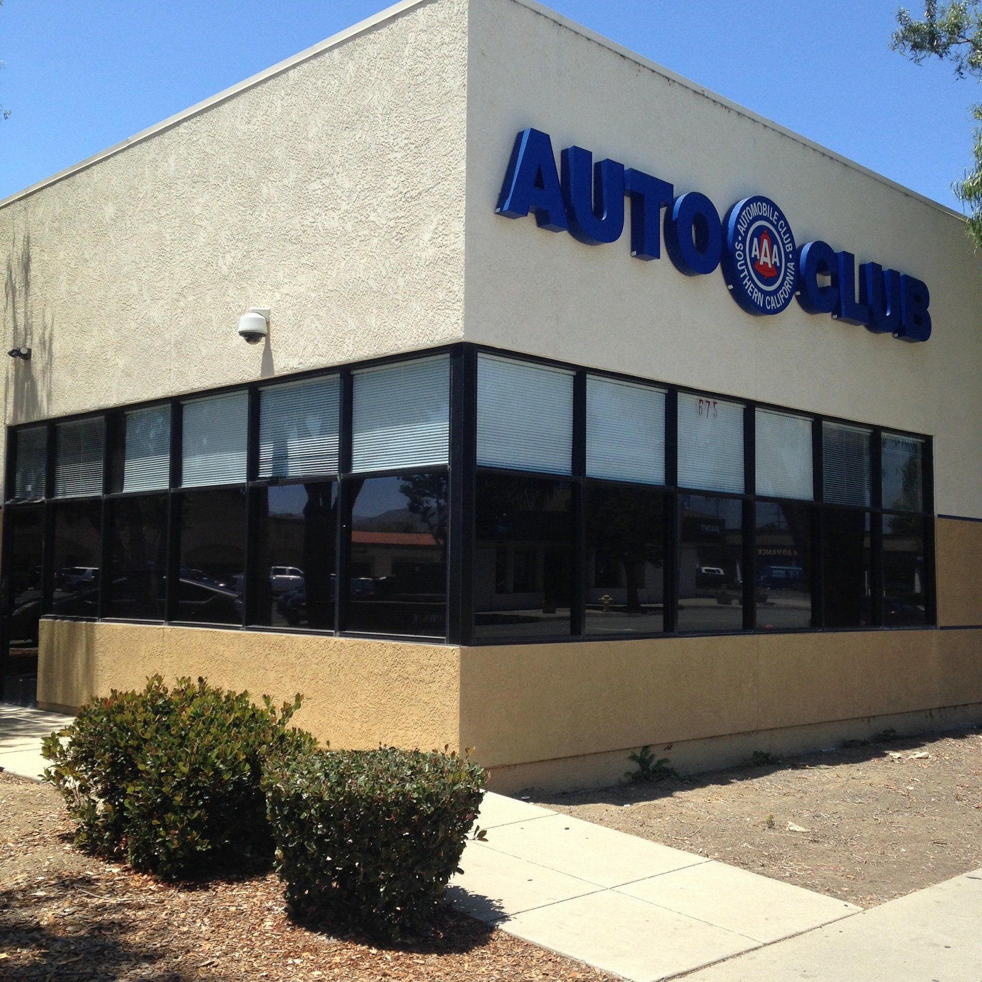 AutoZone store exterior with blue sign and large storefront windows on a sunny day