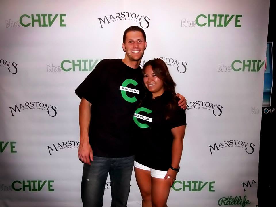 Two people posing together at a CHIVE and Marstons event backdrop, both wearing black CHIVE shirts.