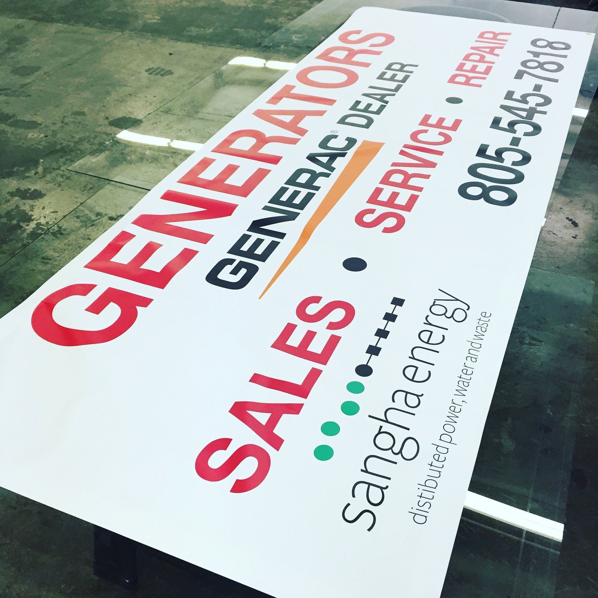 Tilted white business sign with red and black text for Generators, Sales, Service, and Santha energy.
