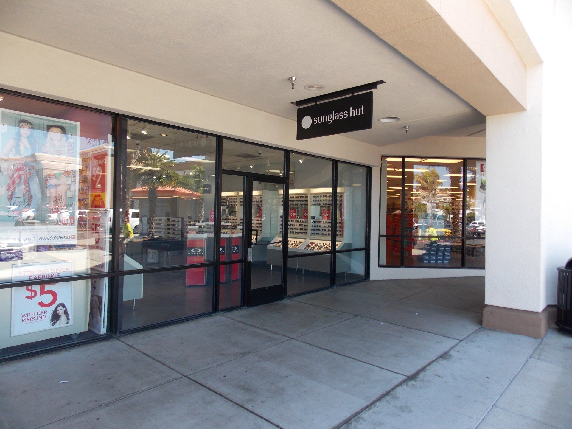Storefront entrance with glass doors and windows under a covered walkway