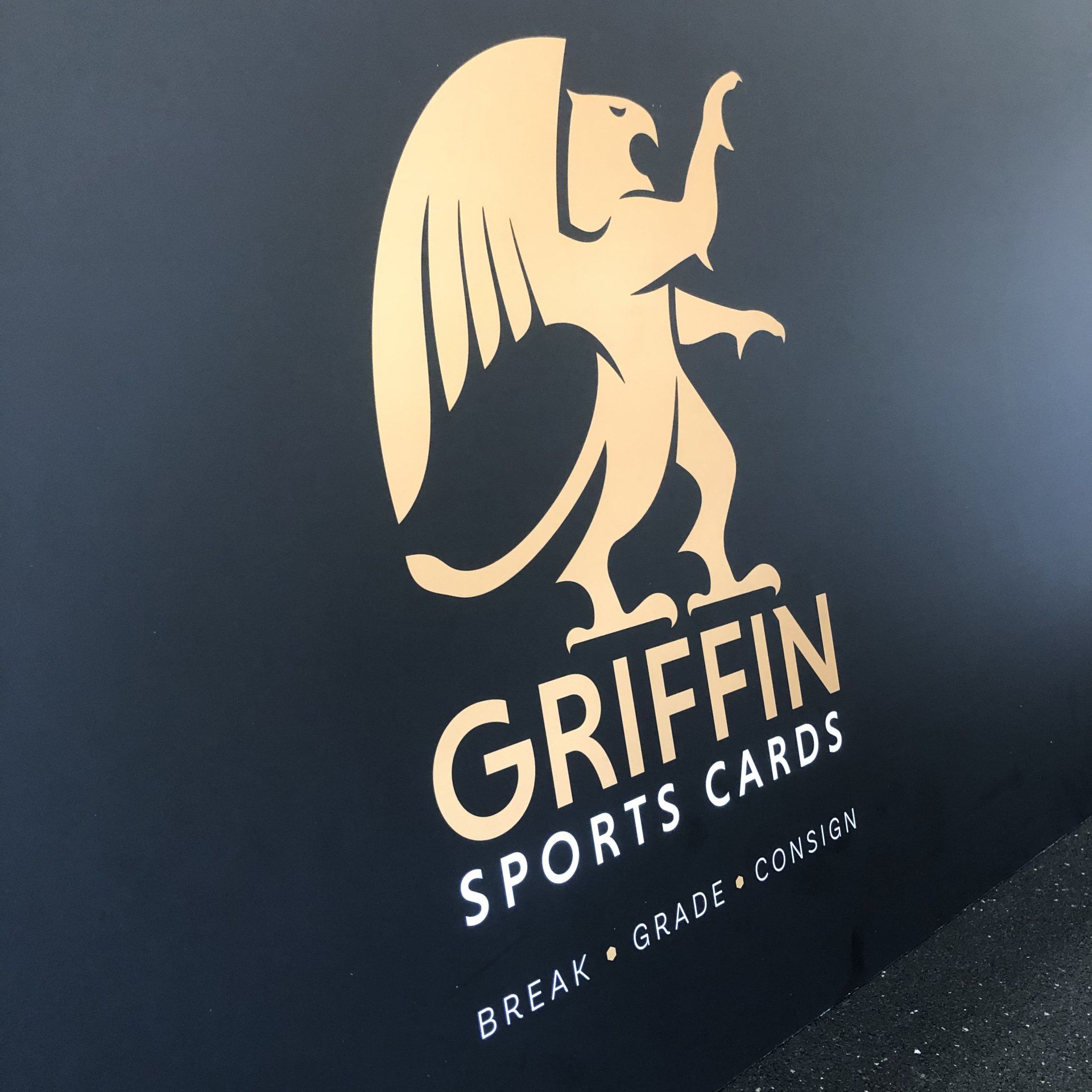 Gold griffin logo with “GRIFFIN SPORTS CARDS” on a dark blue background