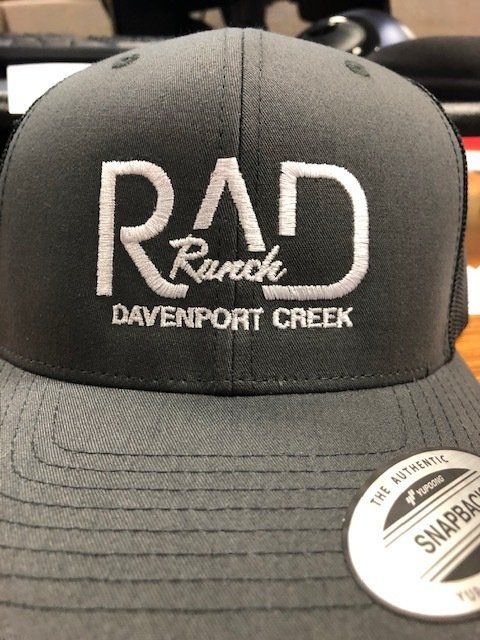 Black RADD Davenport Creek trucker cap with white logo and Snapback sticker