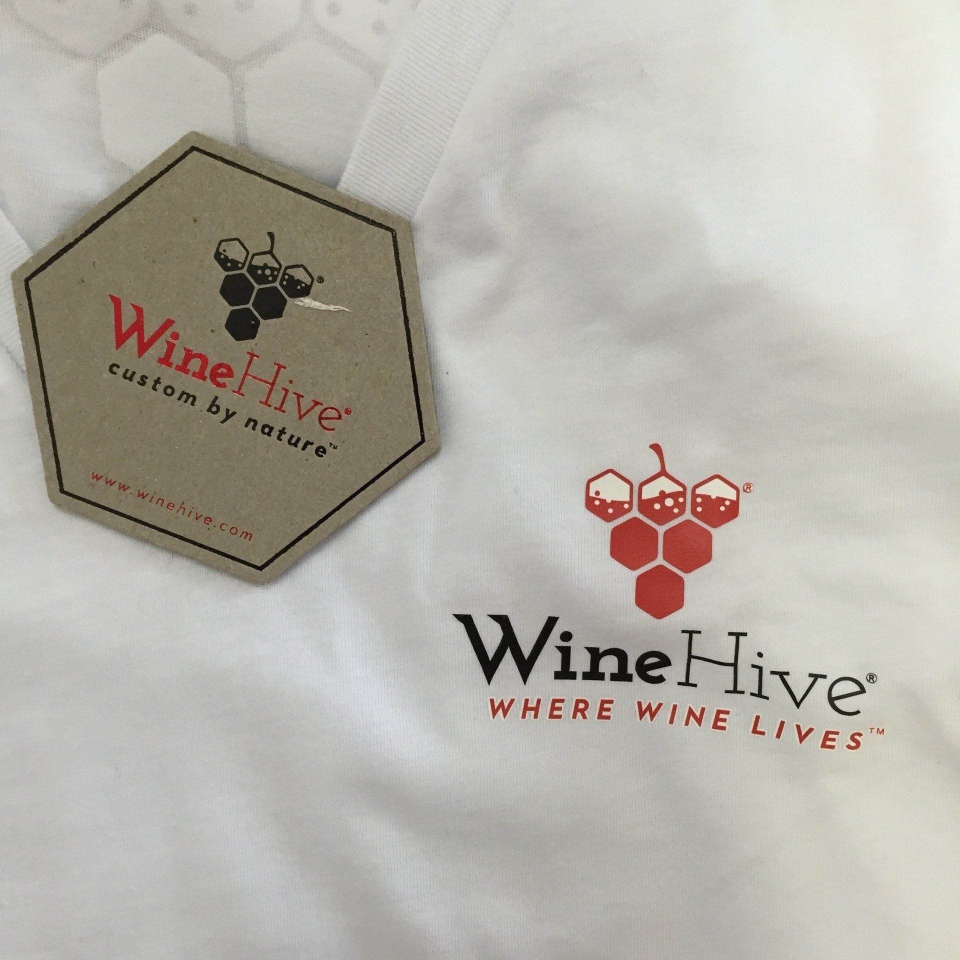 WineHive logo on white fabric, with a tan hexagon patch and red-and-black text logo.