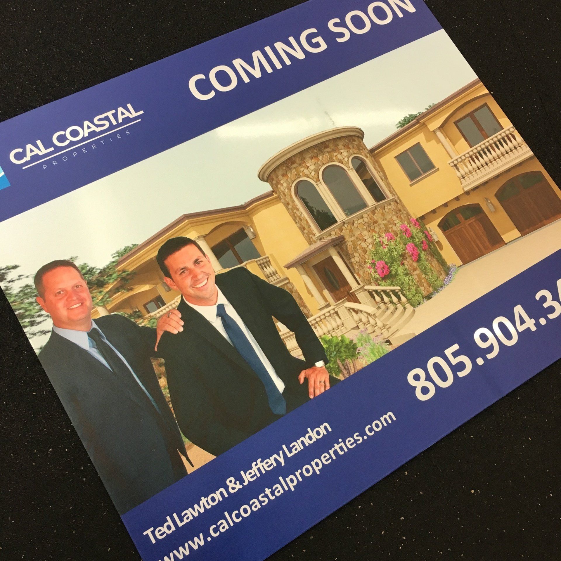 Real estate “Coming Soon” flyer with agents in suits in front of a luxury home