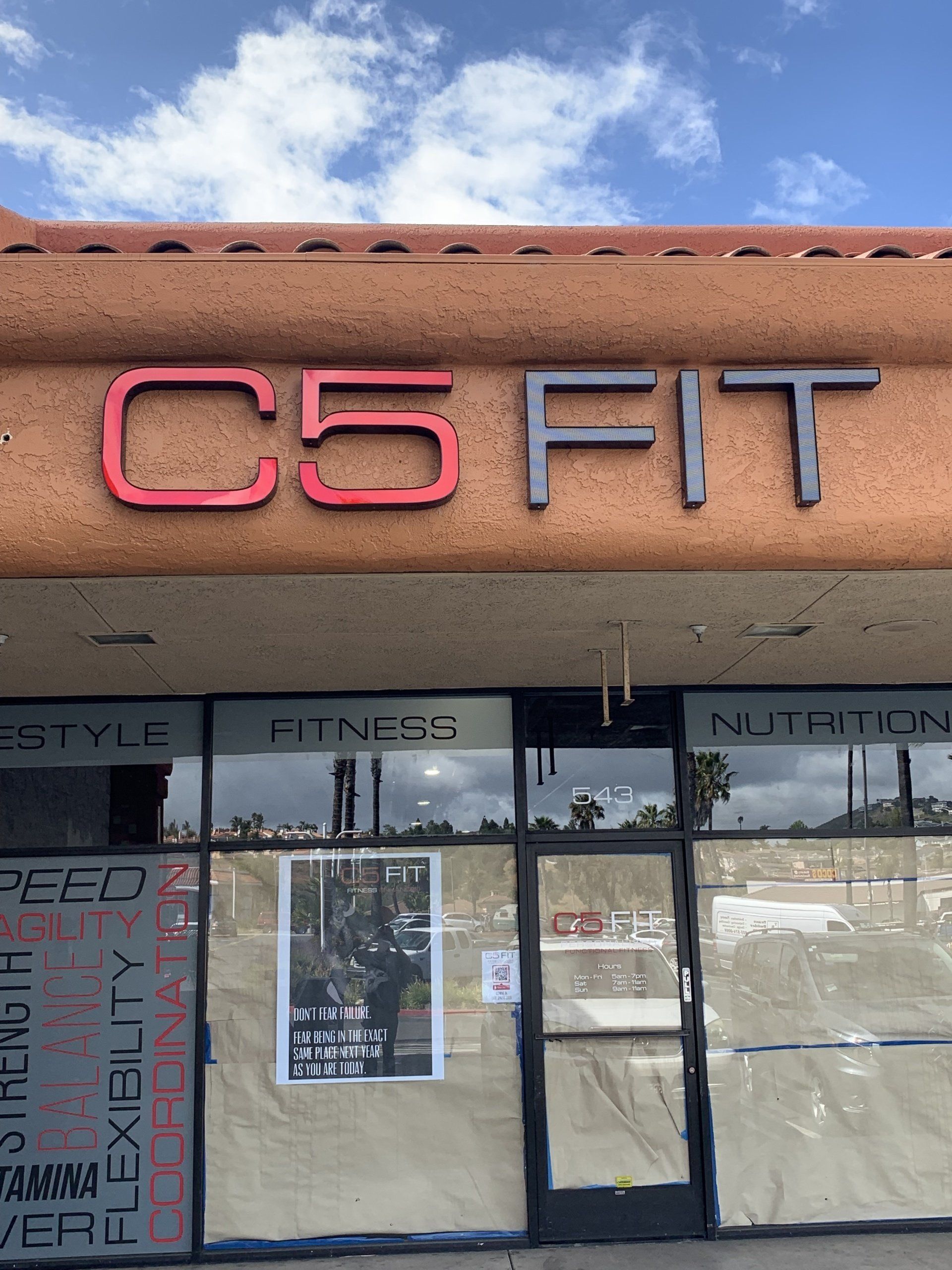 C5 FIT gym storefront with pink and gray sign above glass doors and windows