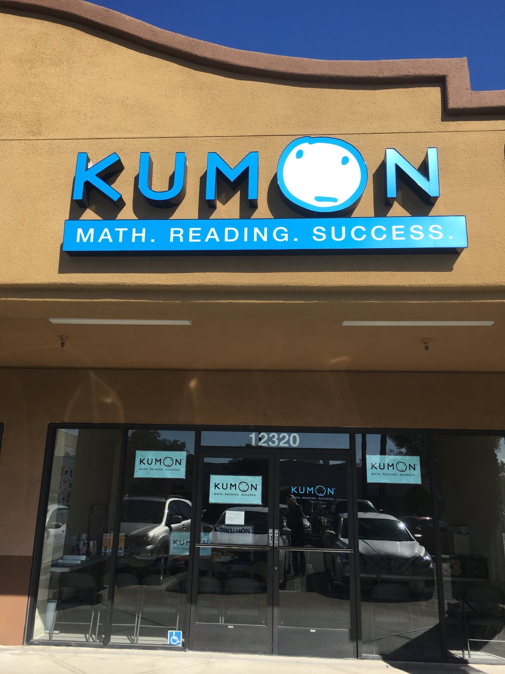 Kumon learning center storefront with blue sign and glass entrance under a tan awning