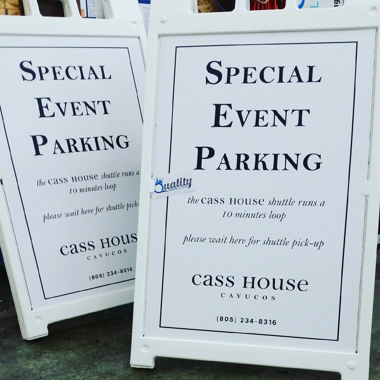 Two white sandwich boards advertising special event parking for Cass House
