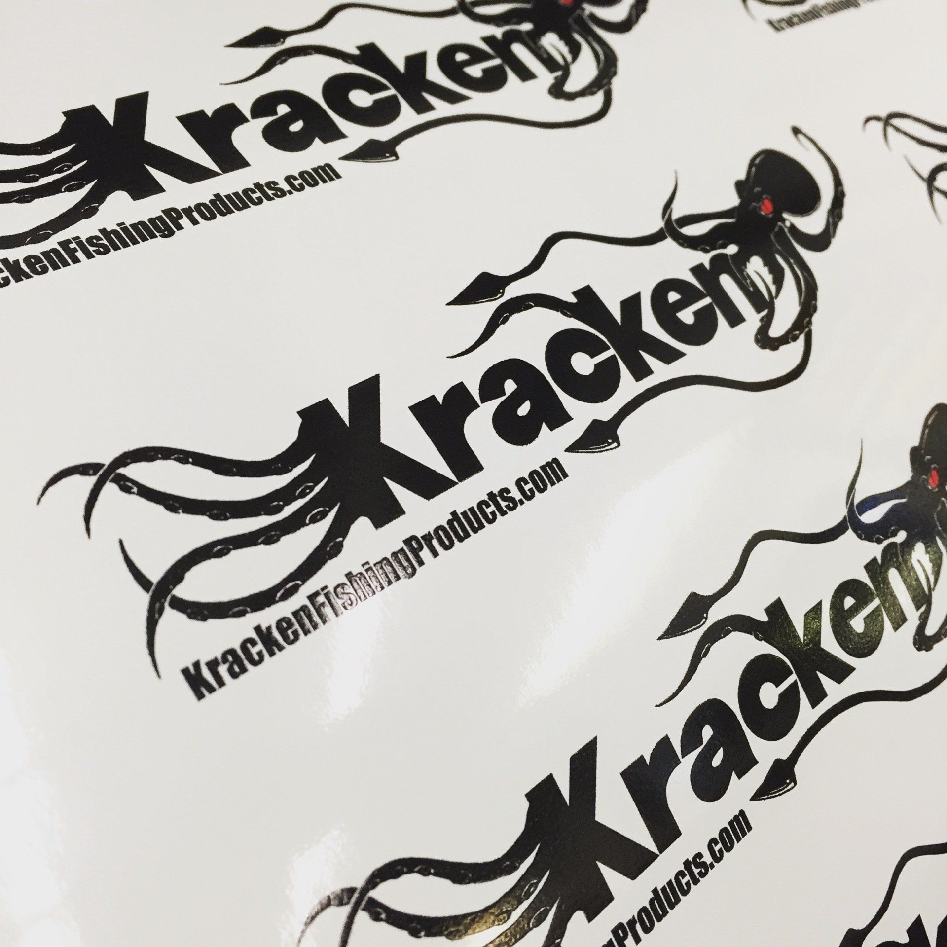 Multiple black Kraken Fish Products logos printed on a white surface.