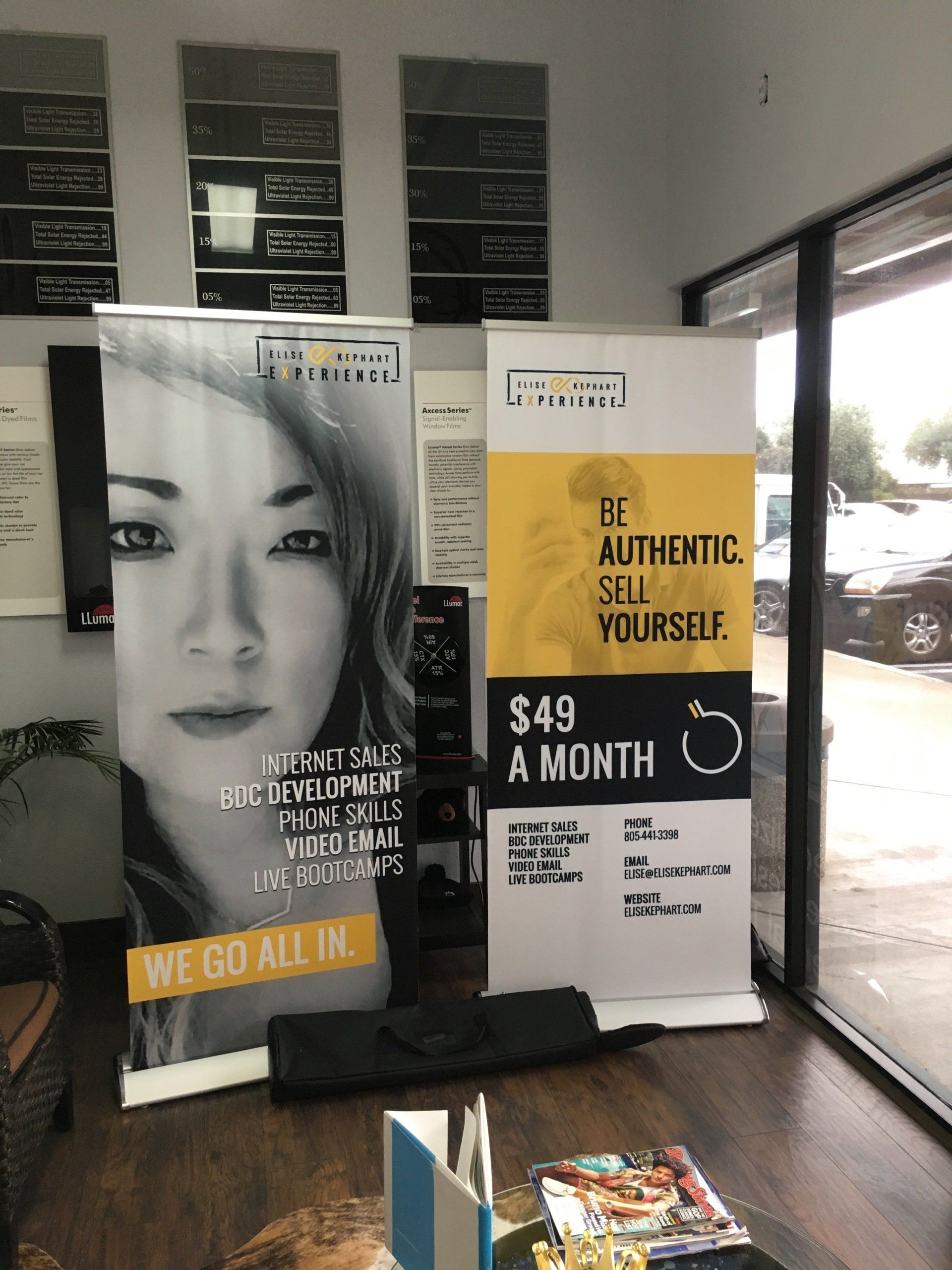Promotional banners in a lobby, one with a black-and-white face and another advertising “3T Authentic Selfies” for $49 a month.