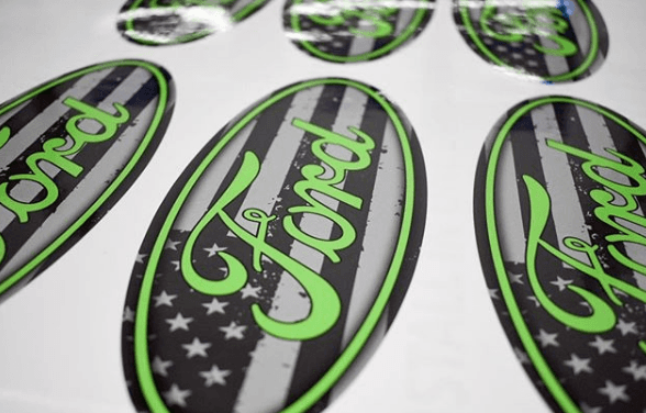 Ford oval stickers with black, green, and star-patterned design on a white background