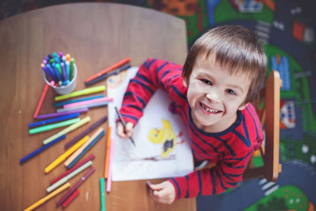 bambino felice mentre mostra un disegno