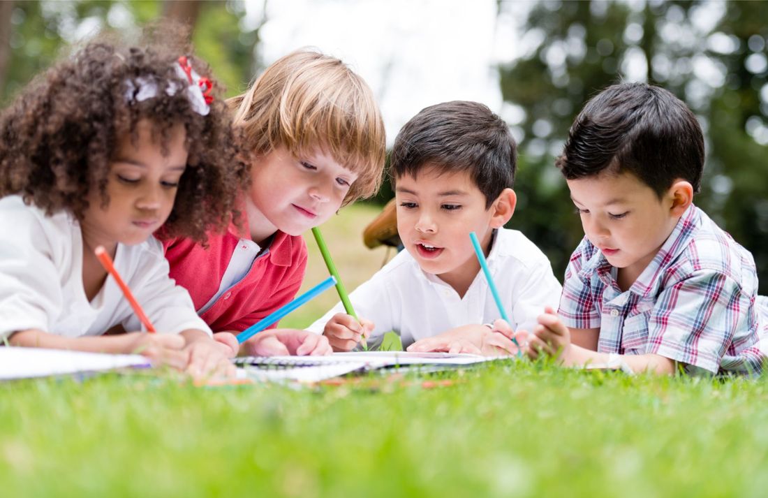 children colouring drawings outdoors