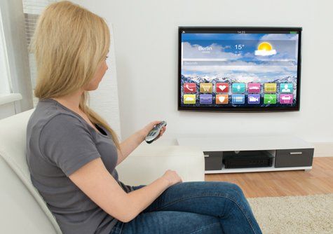 Lady watching TV after IPTV setup service in Nelson