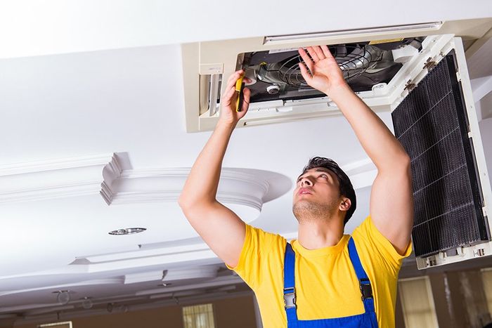 HVAC repairman fixing air ventilation
