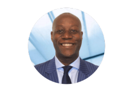 A man in a suit and tie is smiling in a circle.