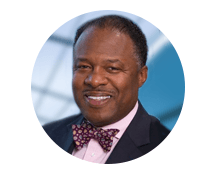 A man in a suit and bow tie is smiling in a circle.