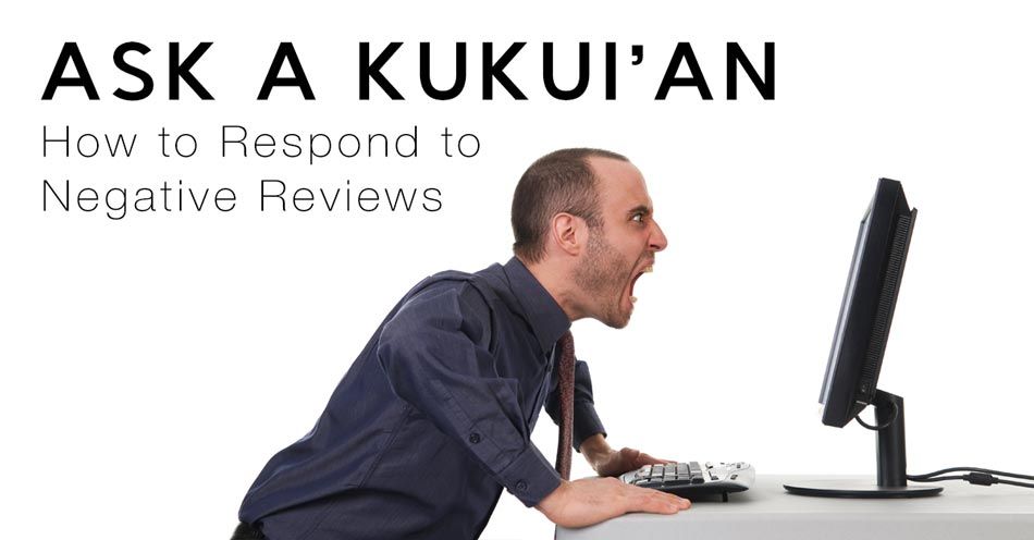 A man is looking at a computer screen with the words ask a kukui 'an above him